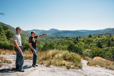 Friends of Panthertown Board Member Mike Purdy points out to Mainspring's Jordan Smith areas where the view would be affected if the land Mainspring hopes to buy were sold to a private owner. 